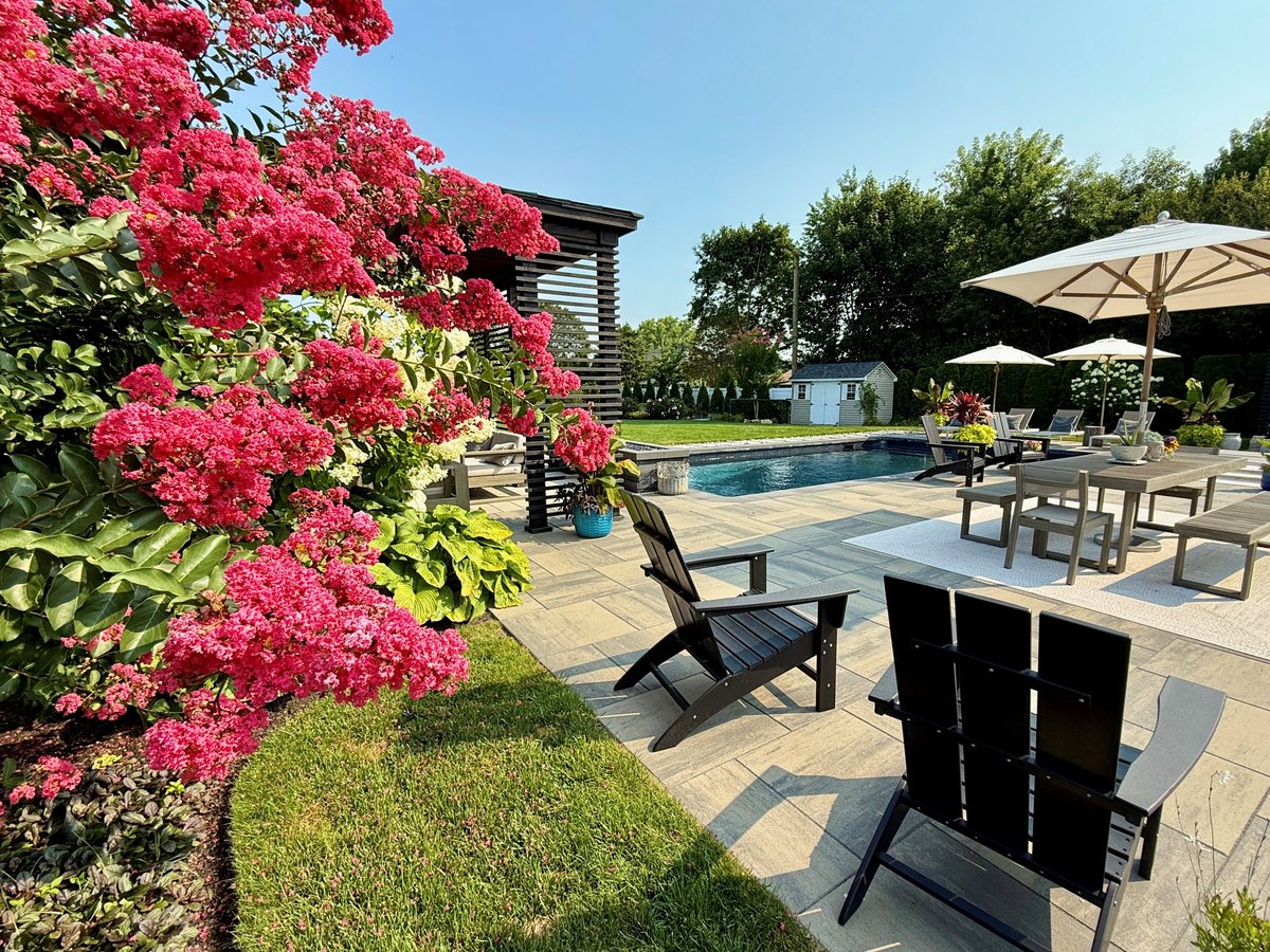 Modern boho garden with pool, lush plants, and cottage flowers